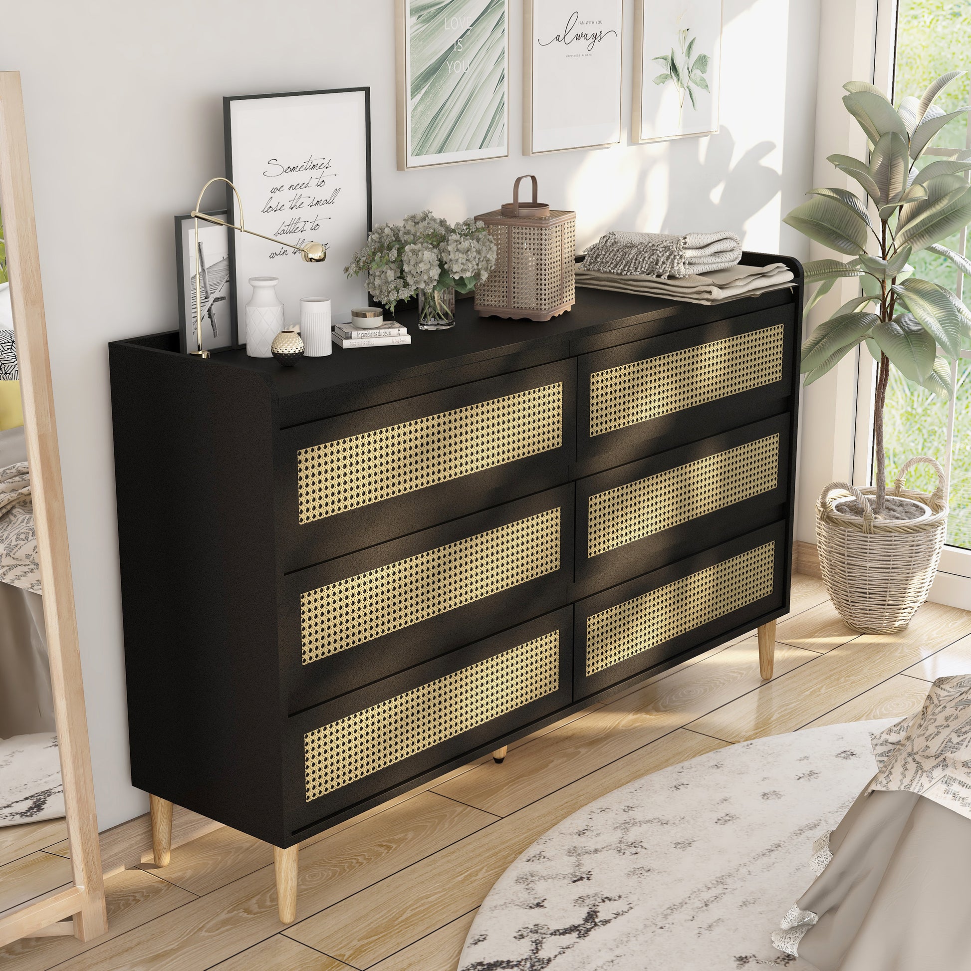 Right angled mid-century modern black and rattan six-drawer dresser in a bedroom with accessories