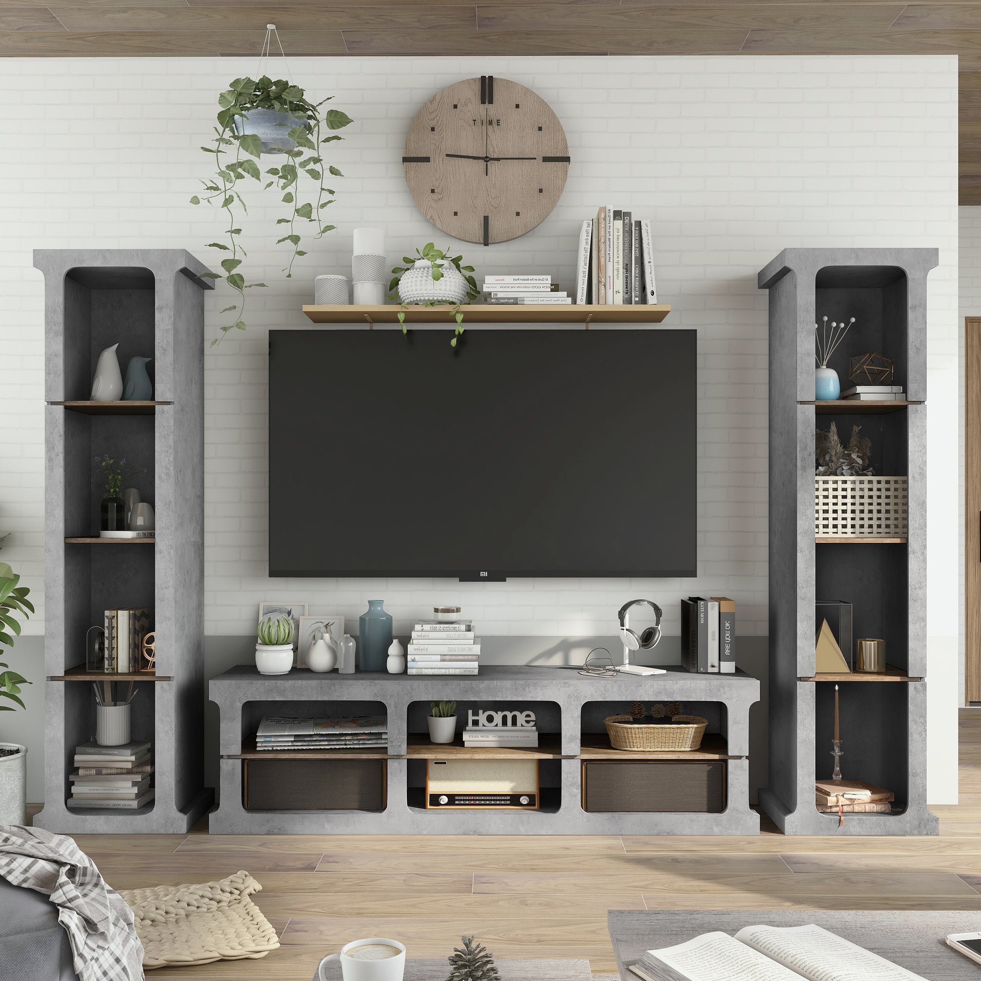 Front-facing industrial cement and wood three-piece TV stand and media tower set in a living area with accessories