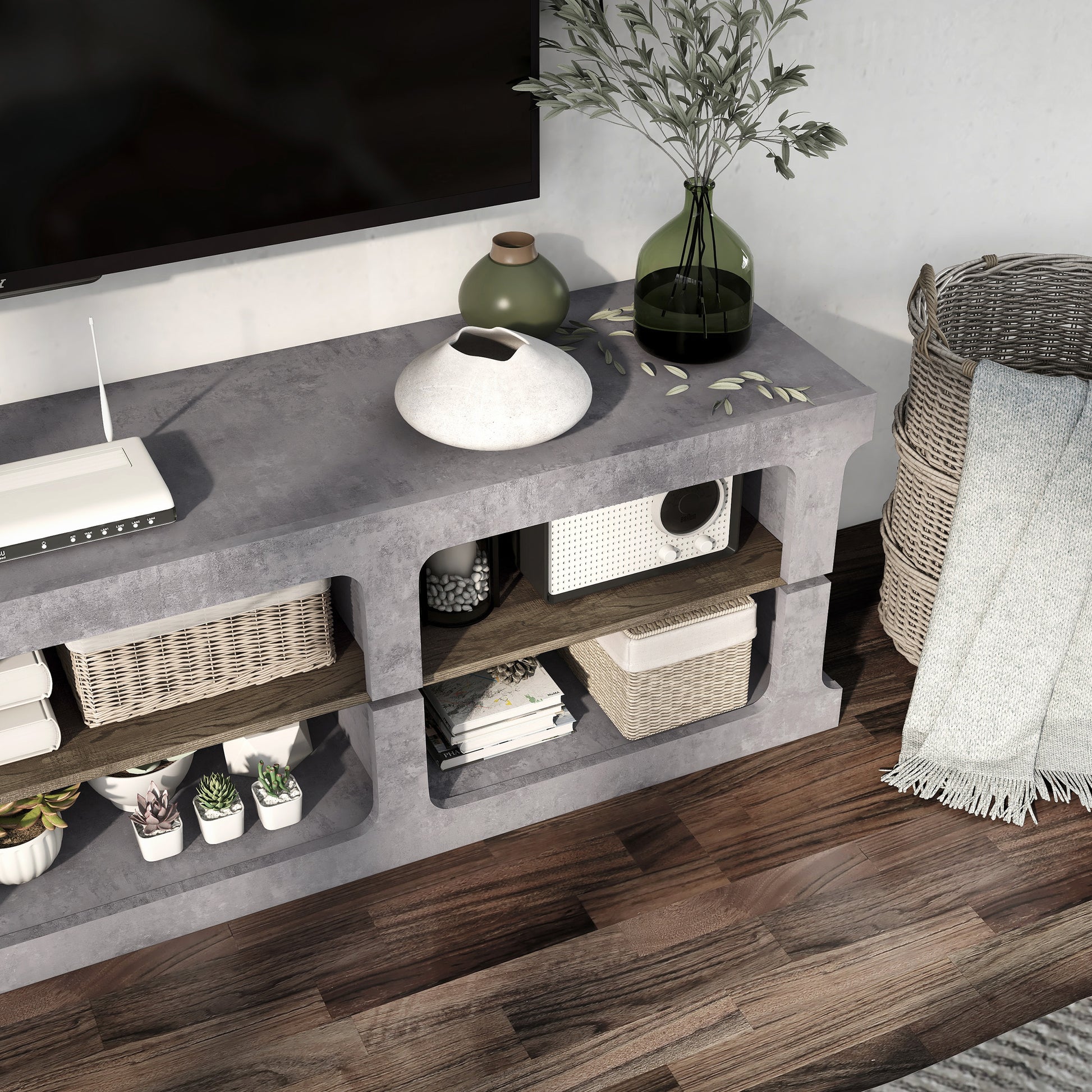 Right angled bird's eye close-up view of an industrial cement and wood six-shelf TV stand in a living area with accessories