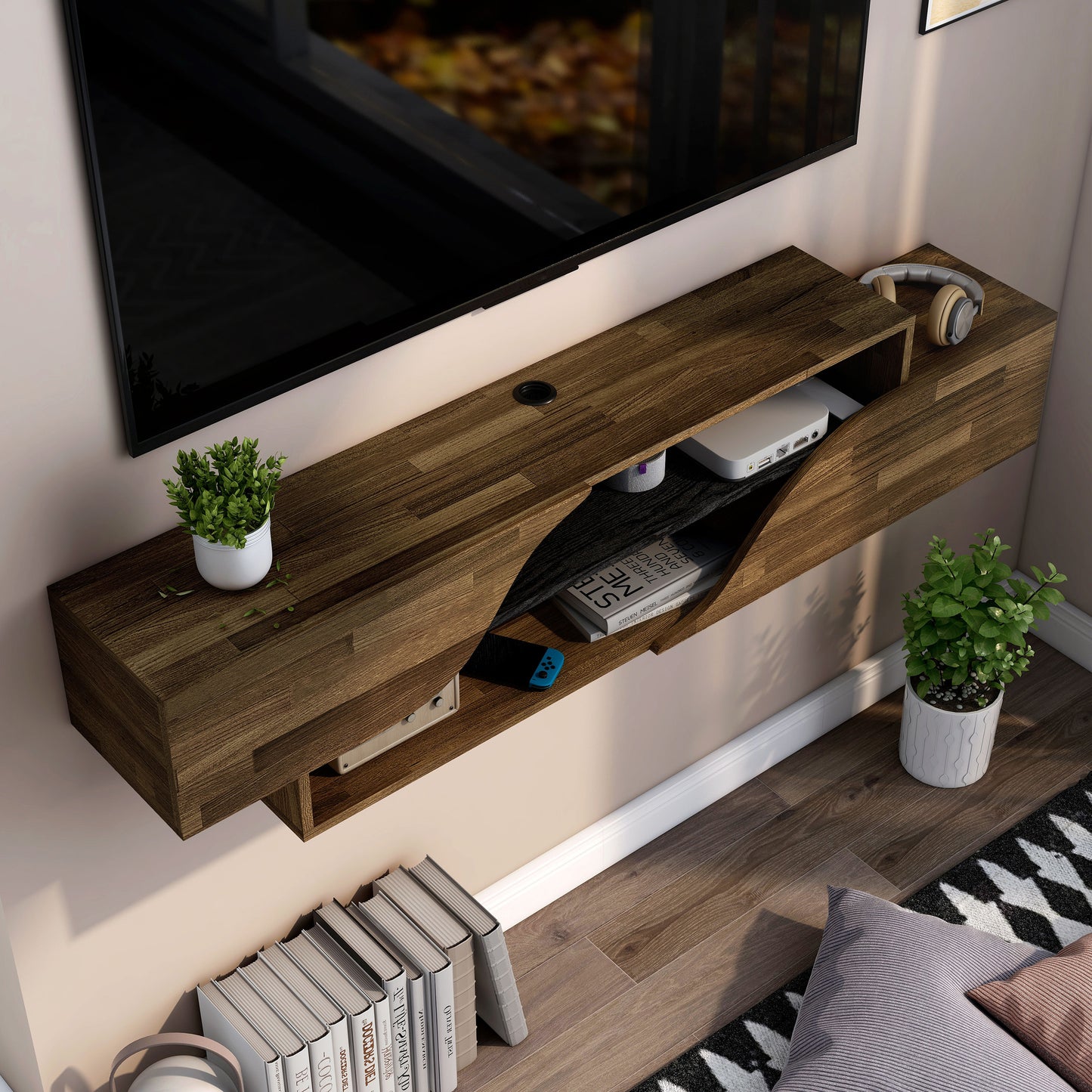 Right angled bird's eye view of a transitional light hickory and black two-shelf floating TV stand in a living room with accessories