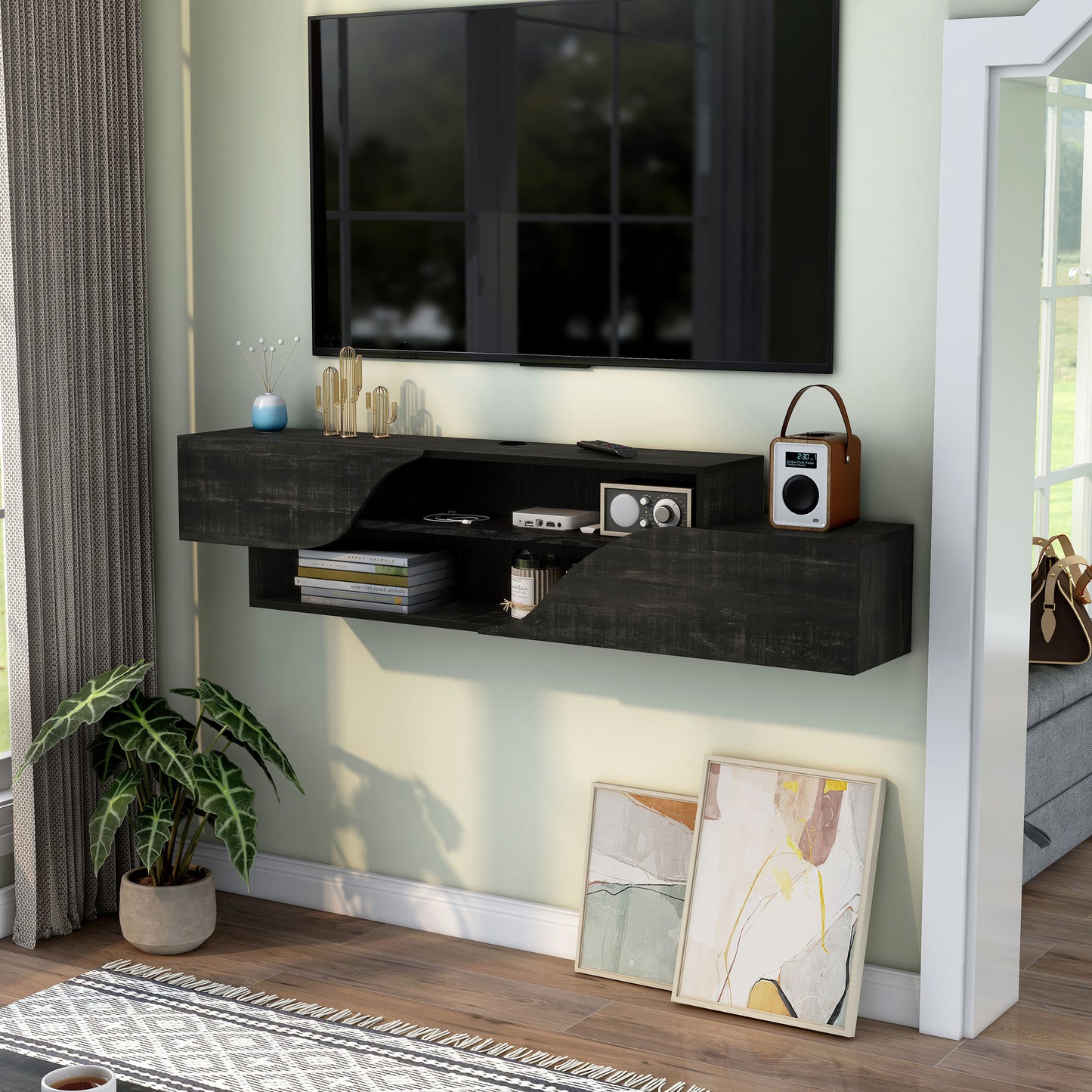 Left angled transitional reclaimed black two-shelf floating TV stand in a living room with accessories