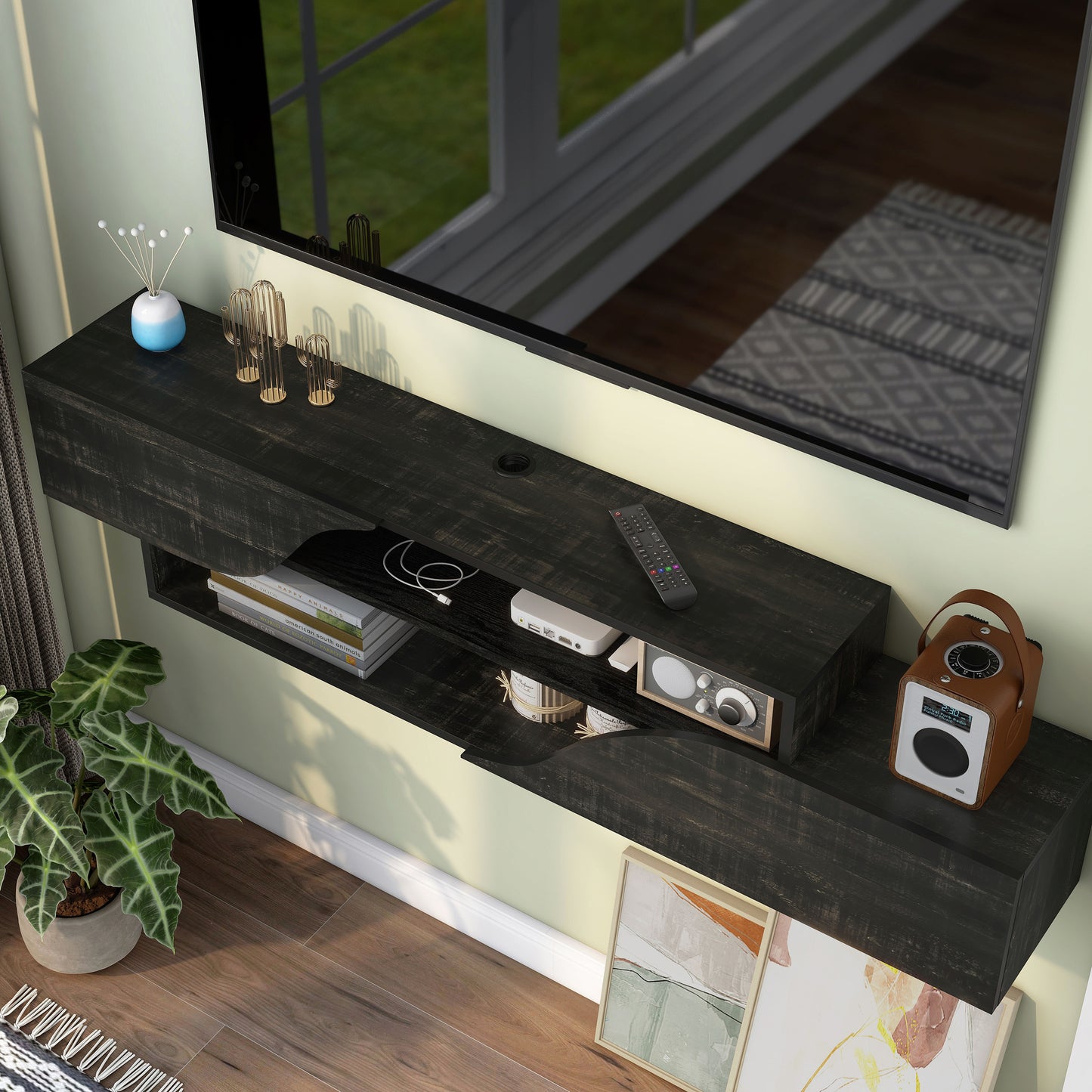 Left angled bird's eye view of a transitional reclaimed black two-shelf floating TV stand in a living room with accessories