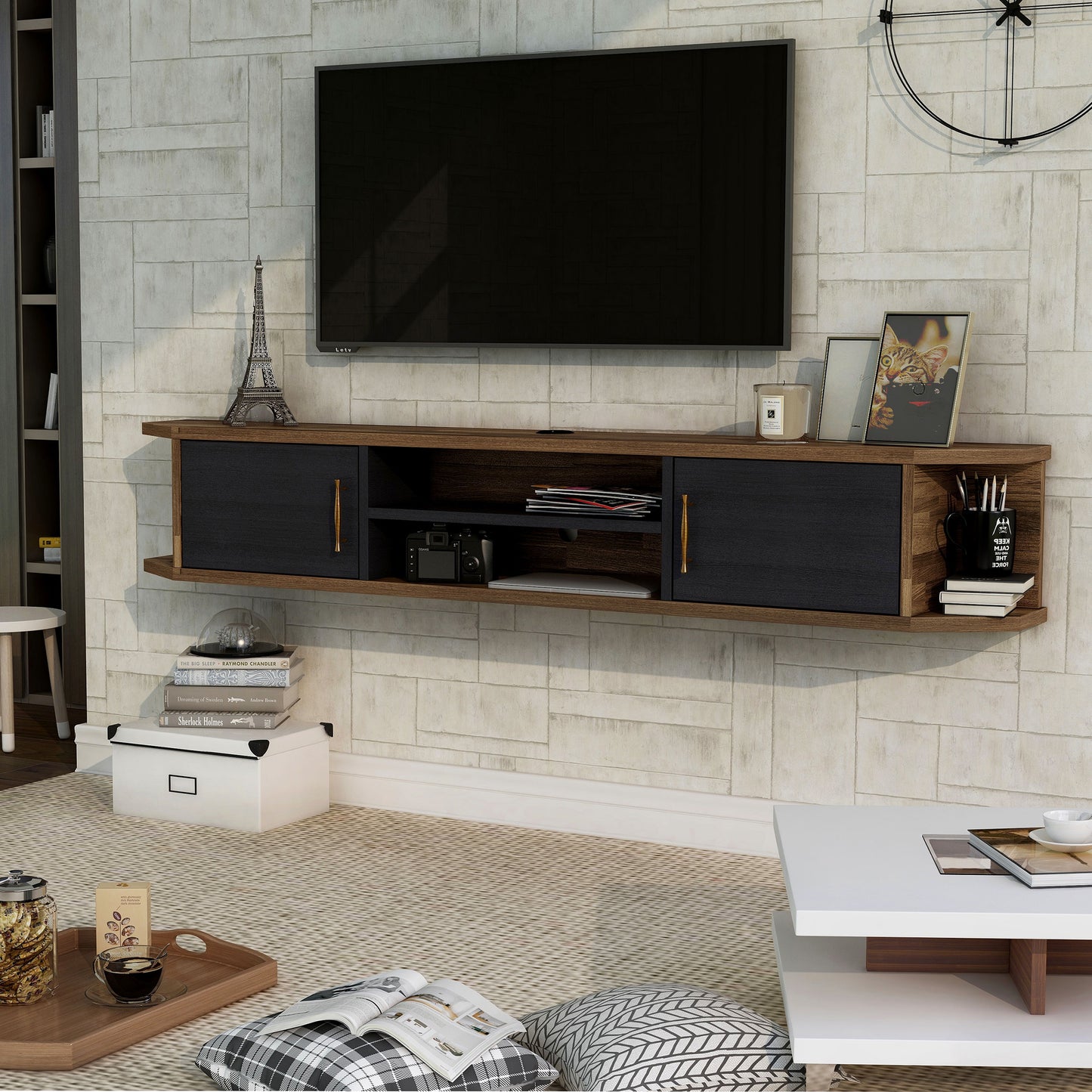 Left angled black and wood two-door four-shelf floating TV stand in a living room with accessories