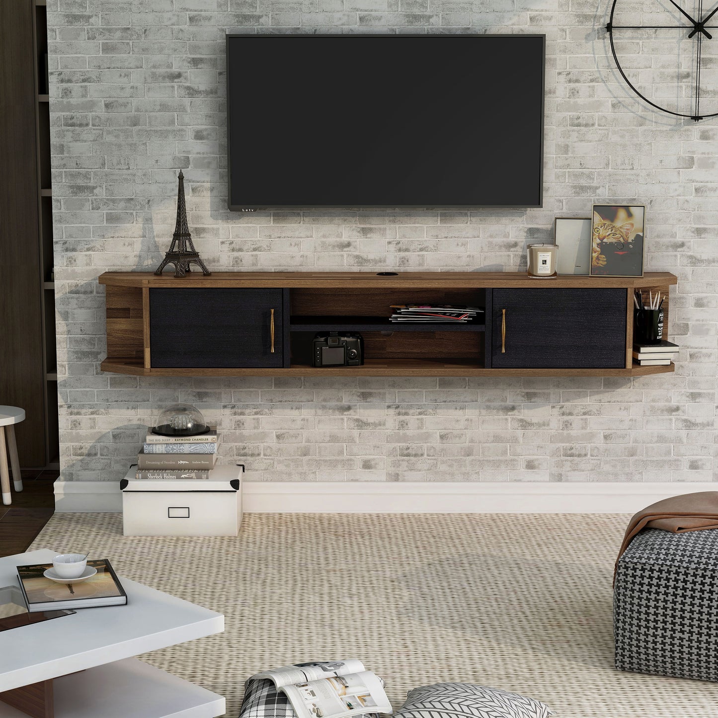 Front-facing black and wood two-door four-shelf floating TV stand in a living room with accessories