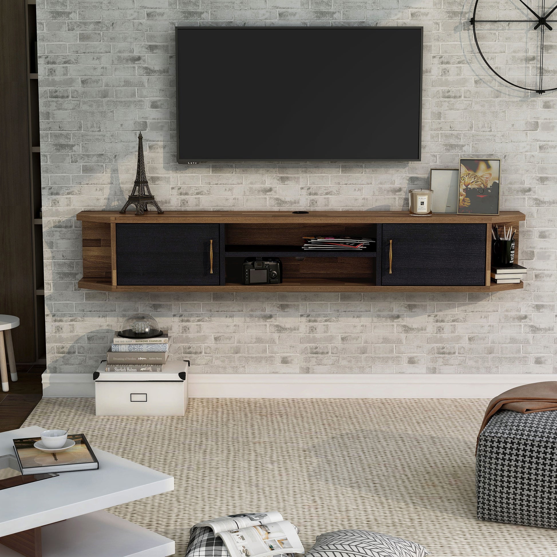 Front-facing black and wood two-door four-shelf floating TV stand in a living room with accessories