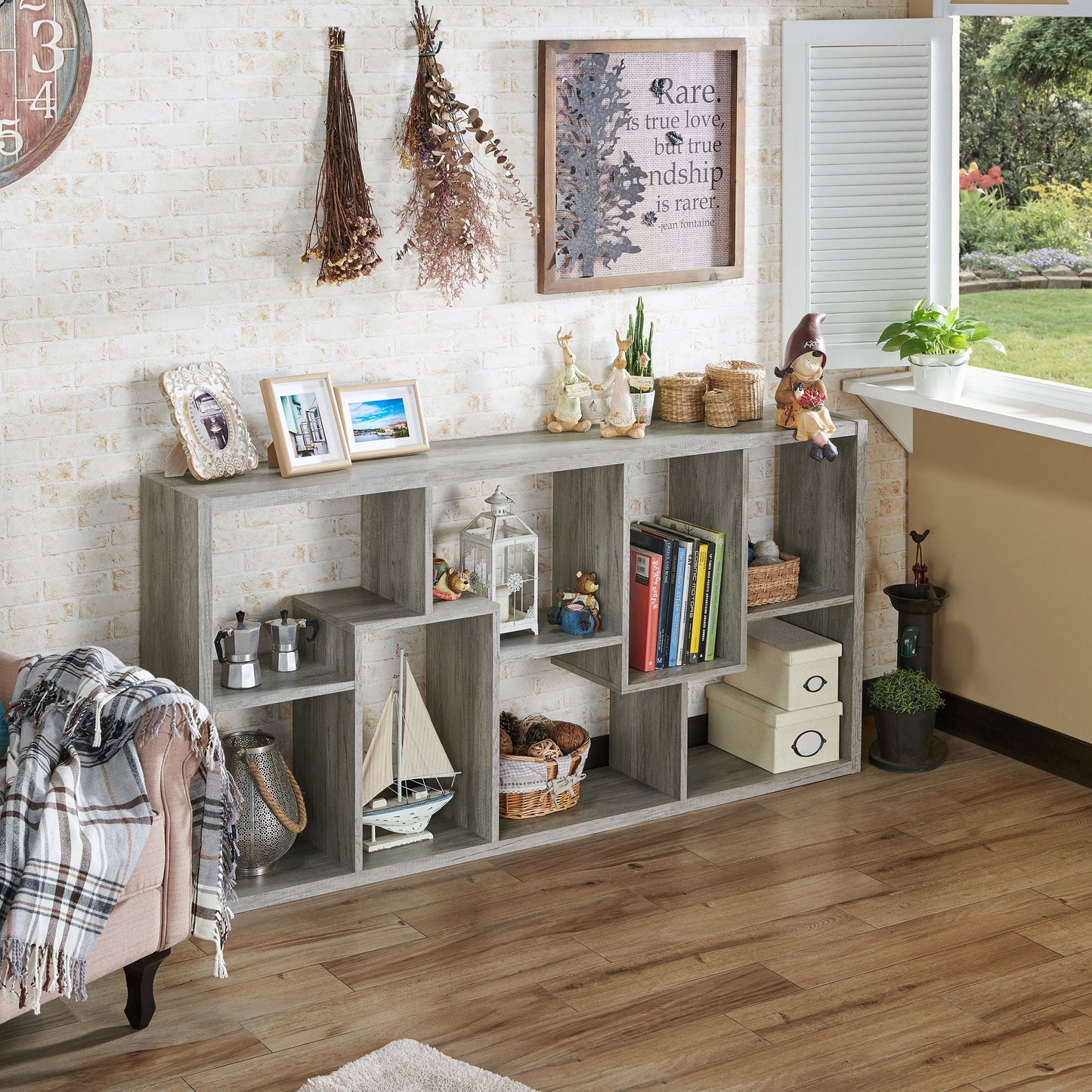 Right angled modern vintage gray oak open geometric bookcase shown horizontally in a living area with accessories