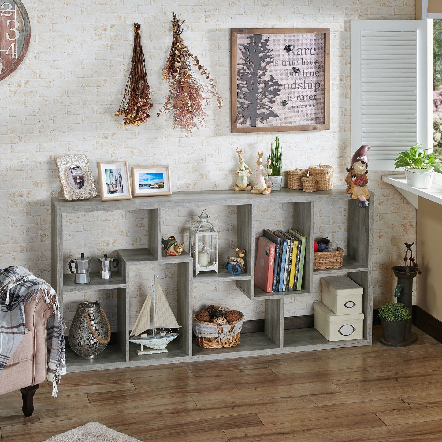 Right angled modern vintage gray oak open geometric bookcase shown horizontally in a living area with accessories