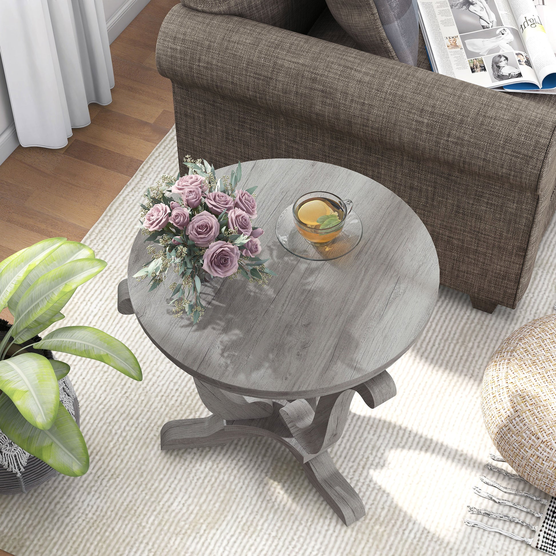 Right angled bird's eye view of one farmhouse vintage gray oak curved pedestal end table in a living room with accessories