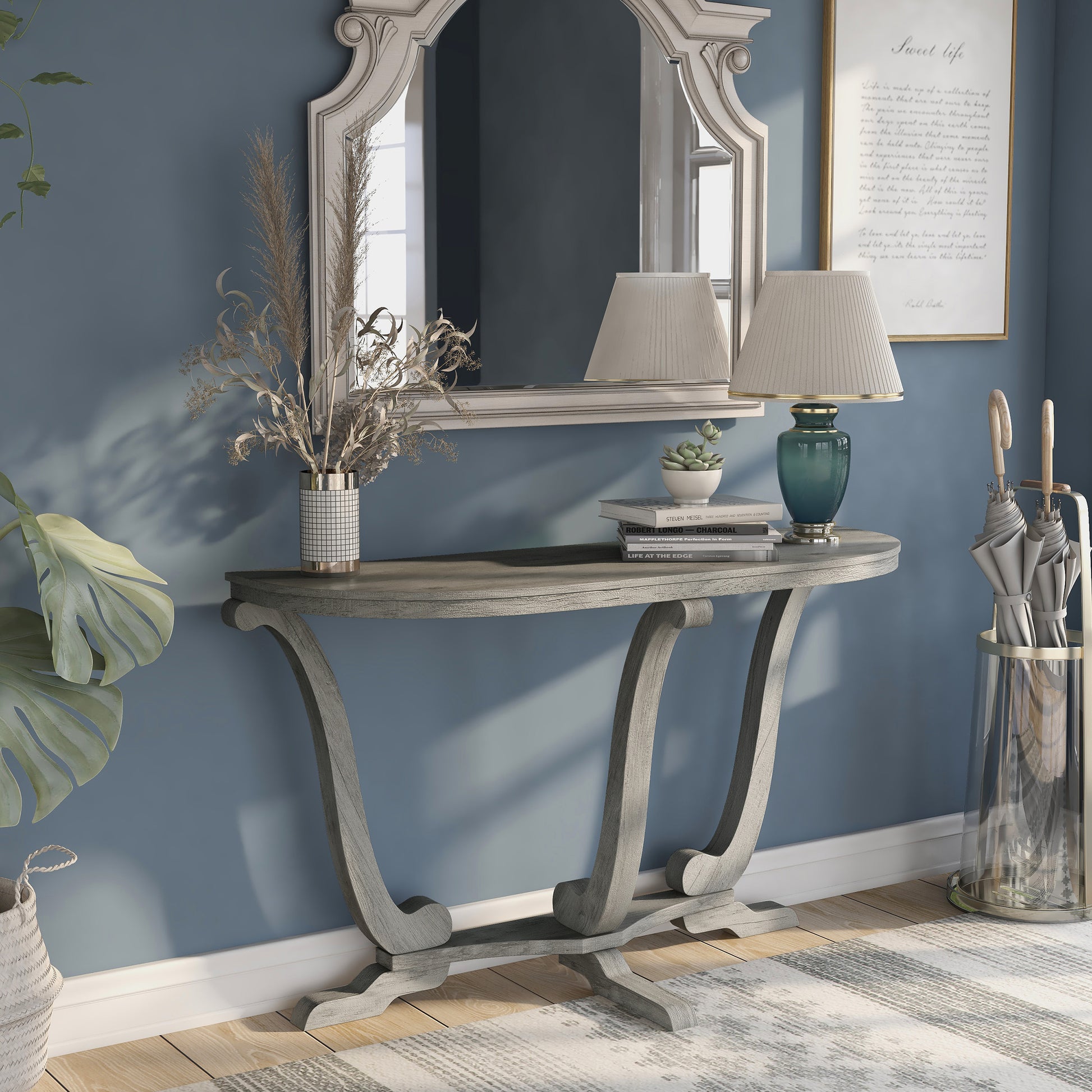 Right angled farmhouse vintage gray oak curved pedestal console table in an entry with accessories
