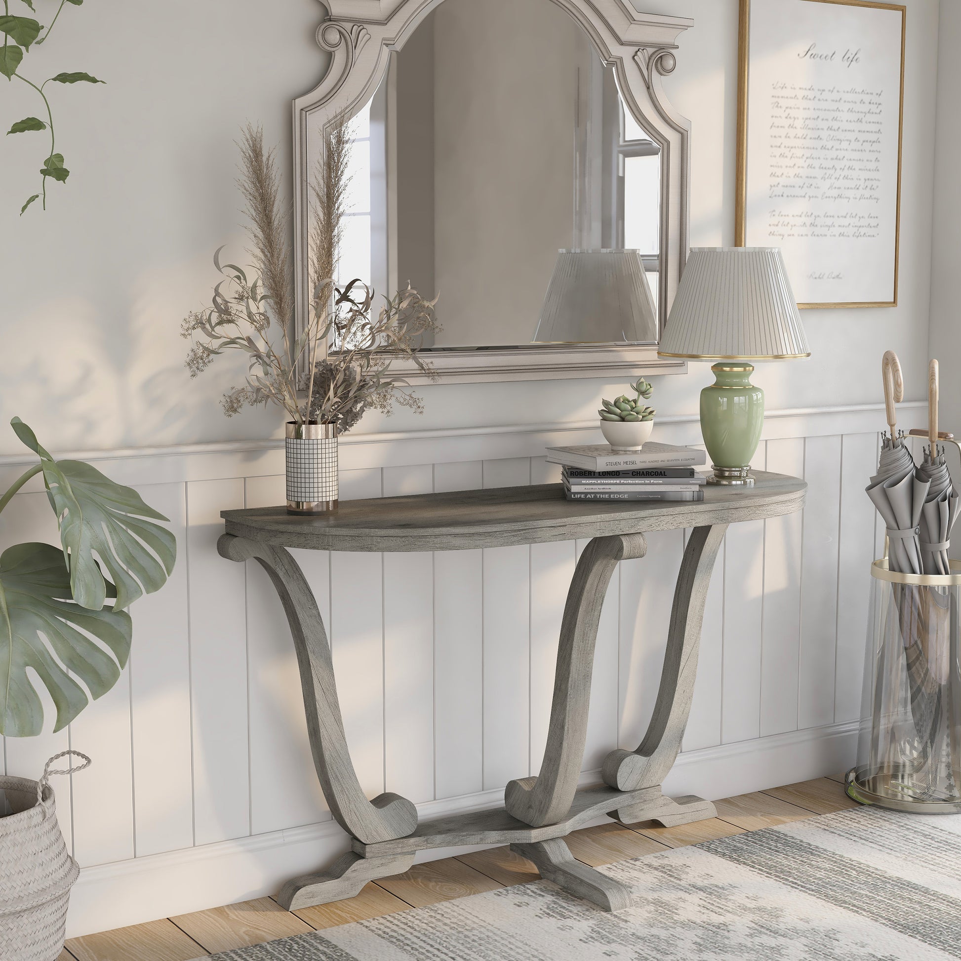 Right angled farmhouse vintage gray oak curved pedestal console table in an entry with accessories