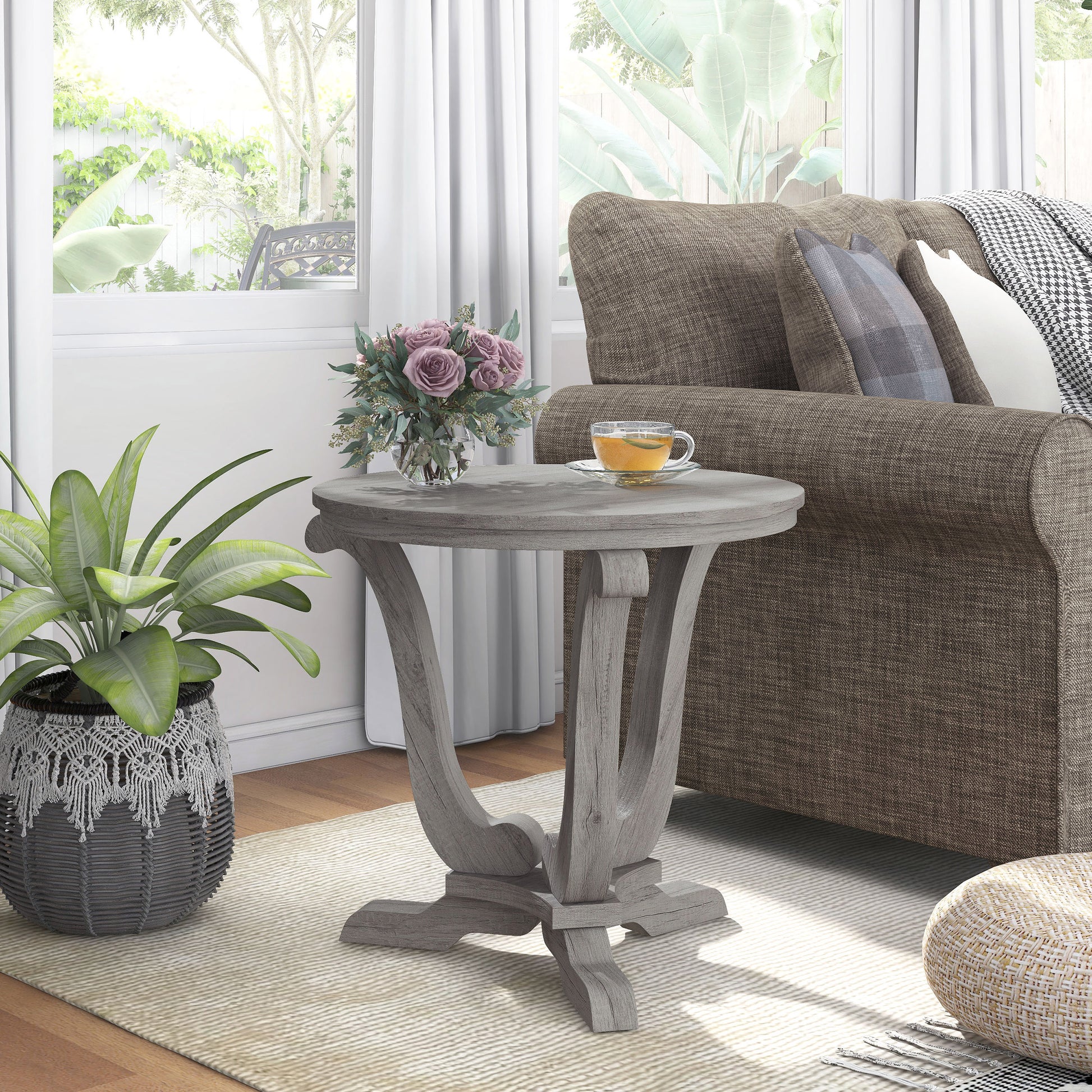 Right angled farmhouse vintage gray oak curved pedestal end table in a living room with accessories