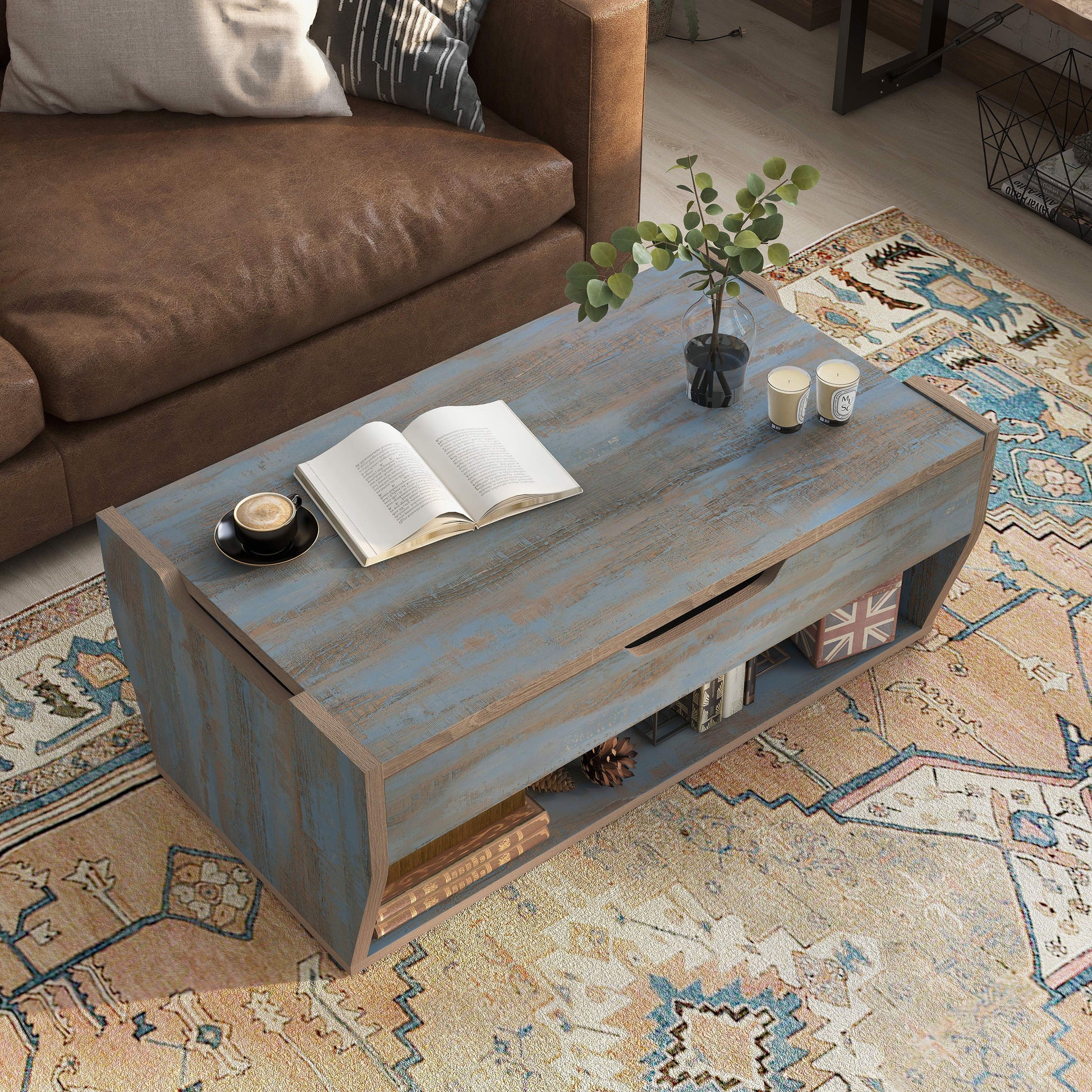 Right angled bird's eye view of a rustic distressed blue lift-top storage coffee table in a living room with accessories