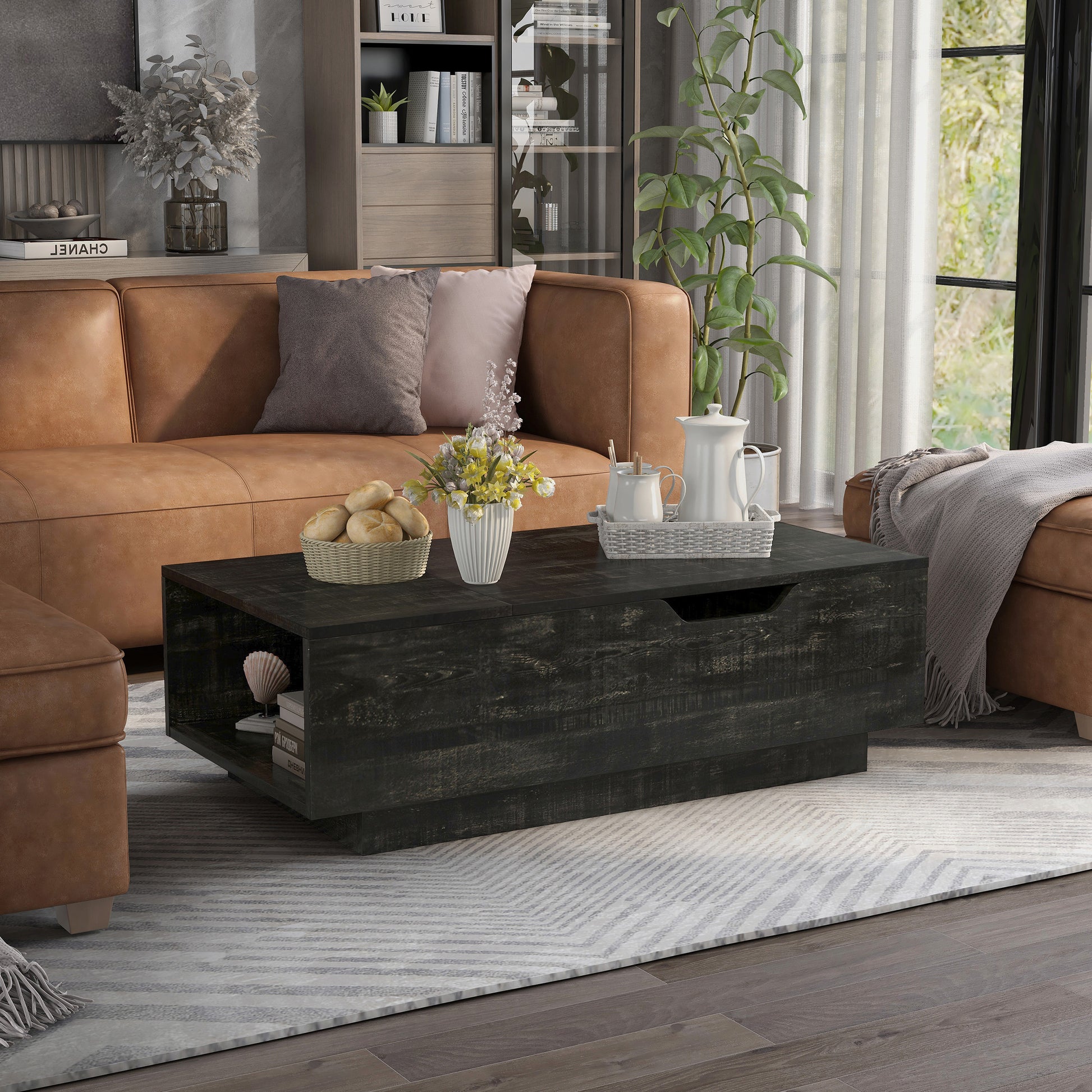 Right angled rustic reclaimed black lift-top storage chest coffee table in a living room with accessories