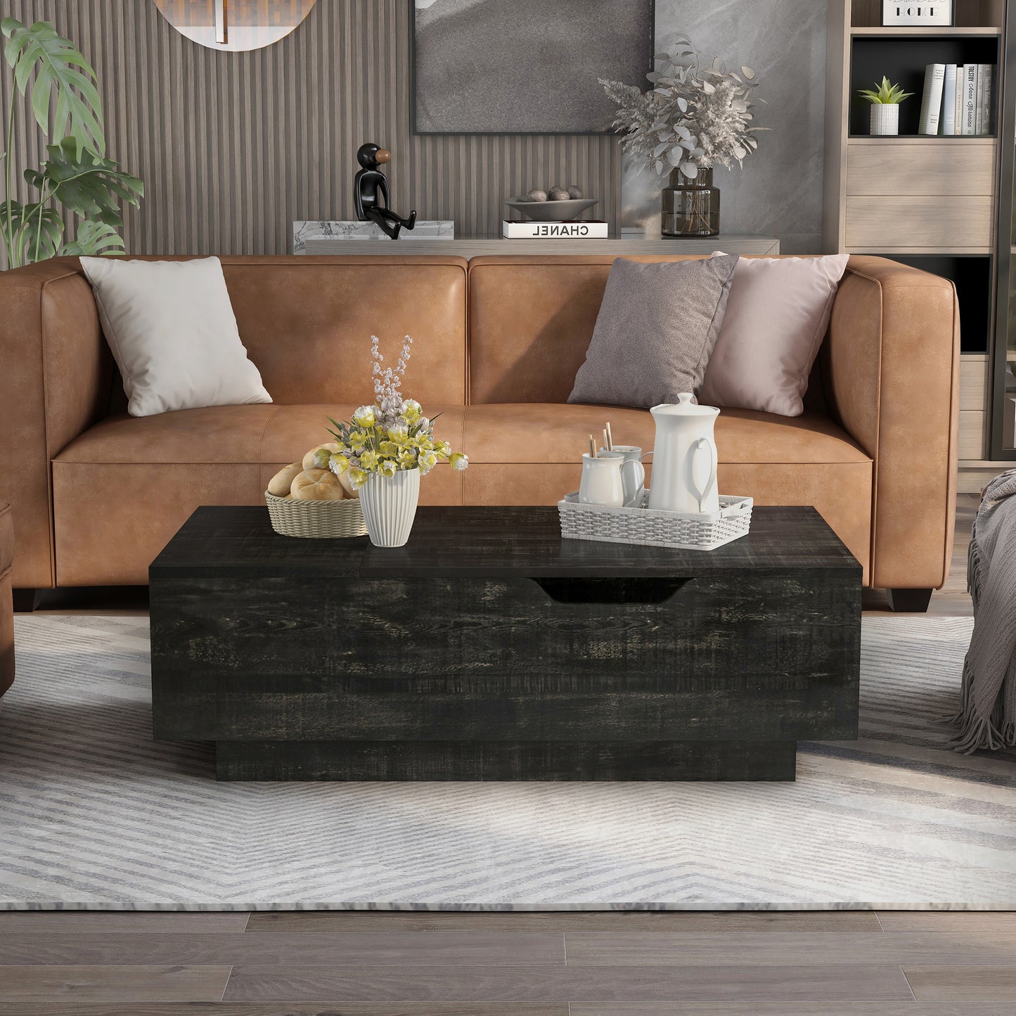 Front-facing rustic reclaimed black lift-top storage chest coffee table in a living room with accessories