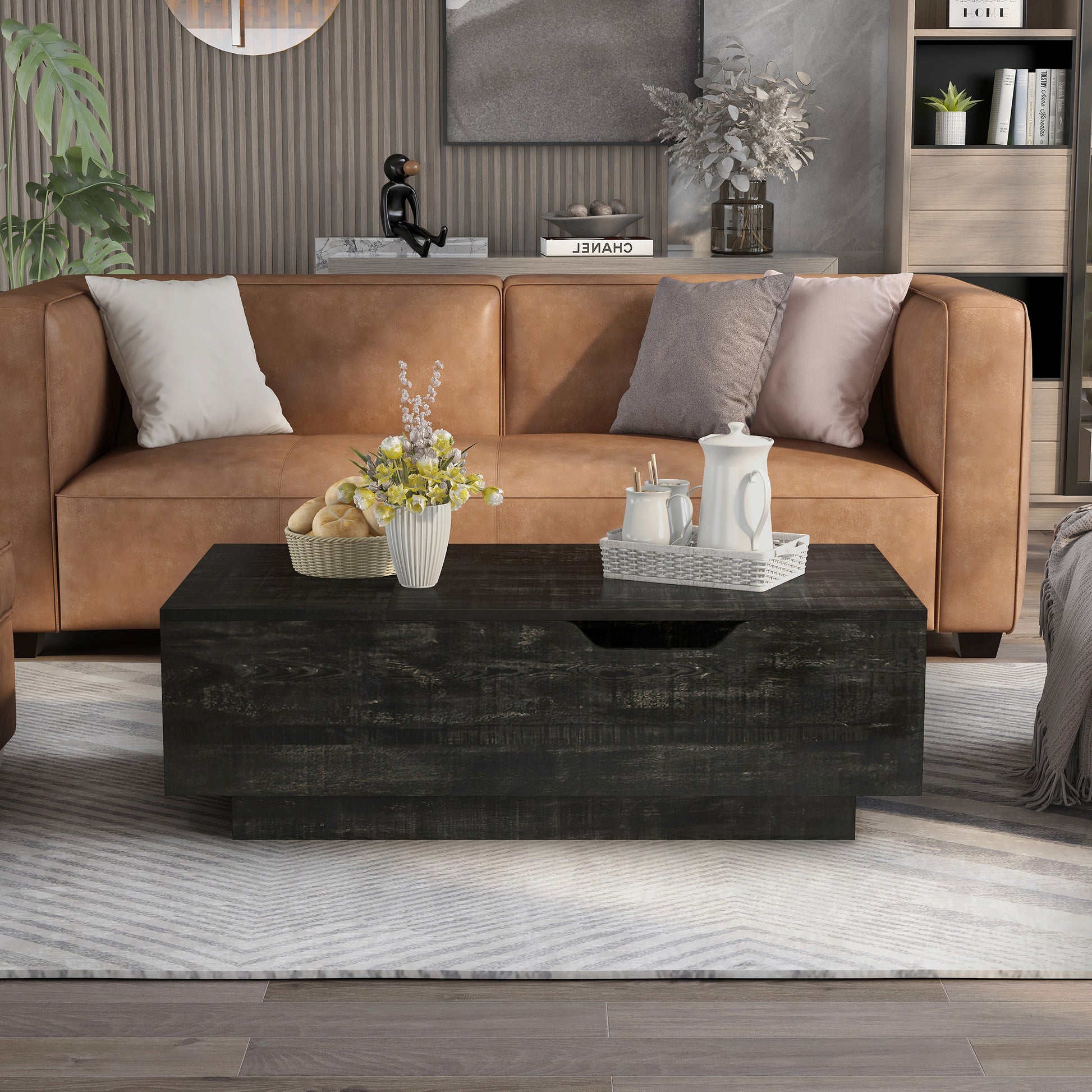 Front-facing rustic reclaimed black lift-top storage chest coffee table in a living room with accessories