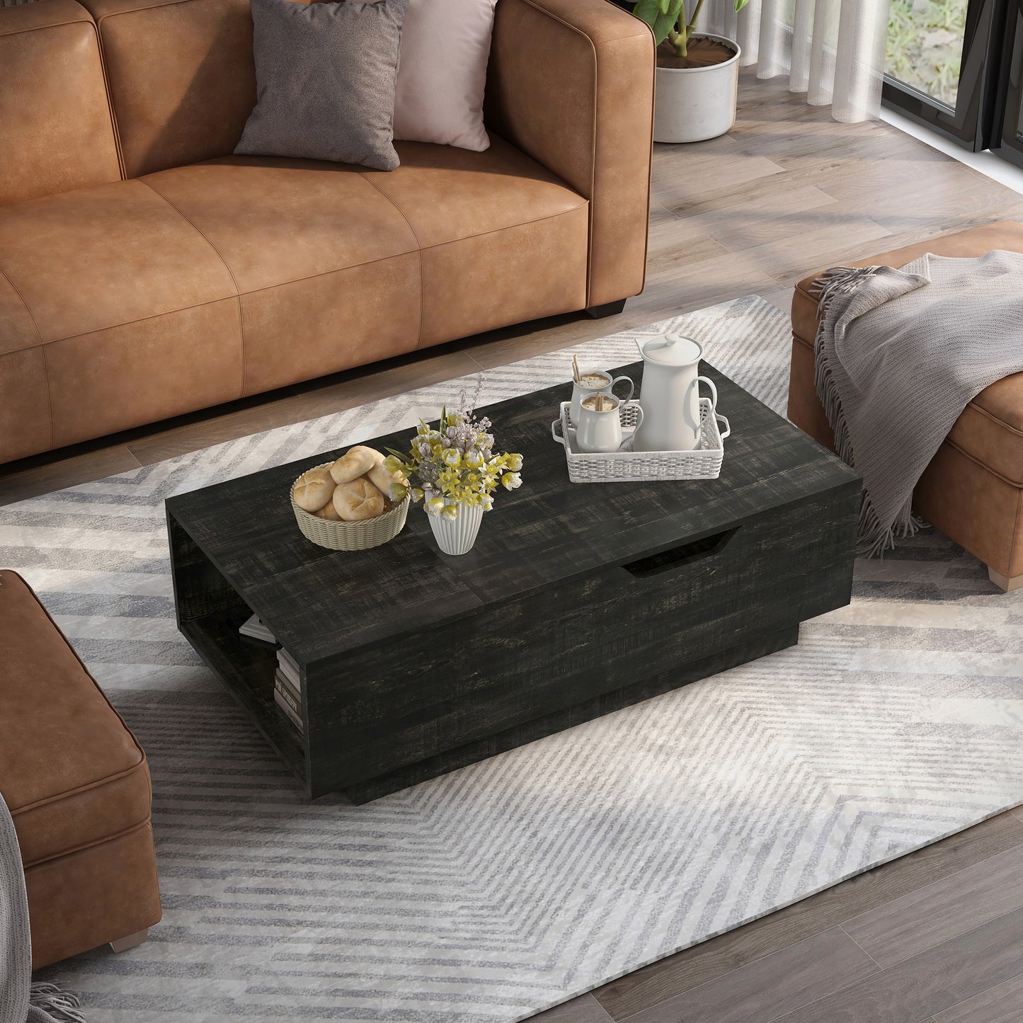 Right angled bird's eye view of a rustic reclaimed black lift-top storage chest coffee table in a living room with accessories