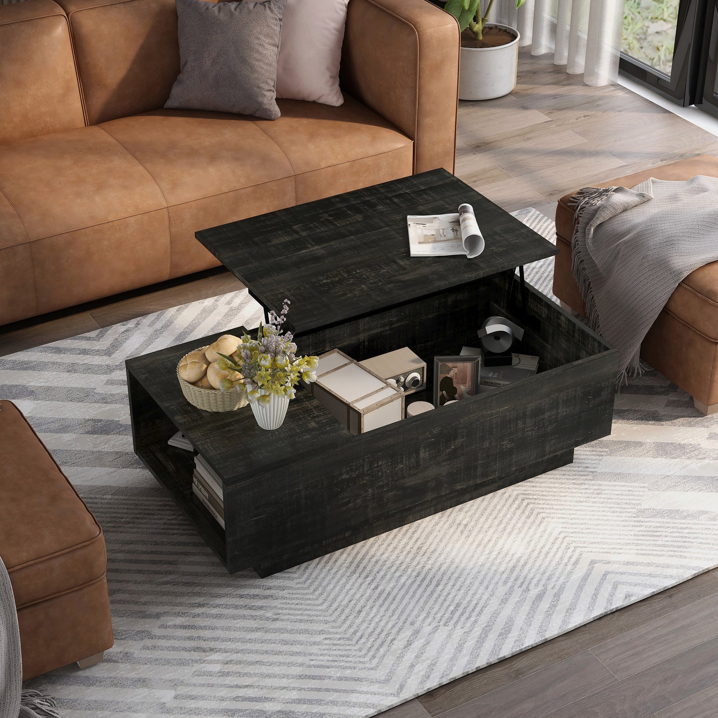 Right angled bird's eye view of a rustic reclaimed black lift-top storage chest coffee table with top up in a living room with accessories