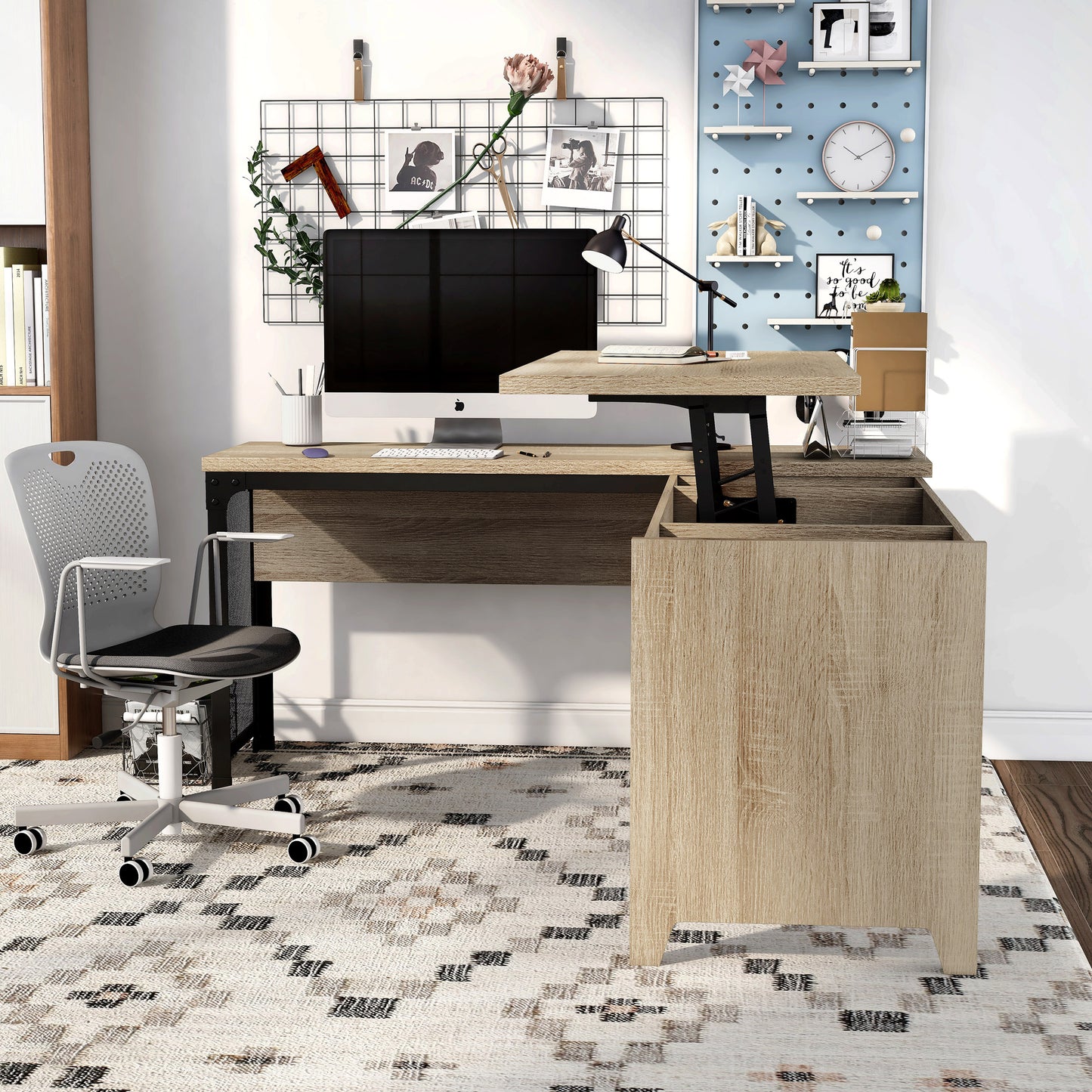 Front-facing industrial natural oak and black mesh L-shaped corner desk with a lift top in a home office with accessories