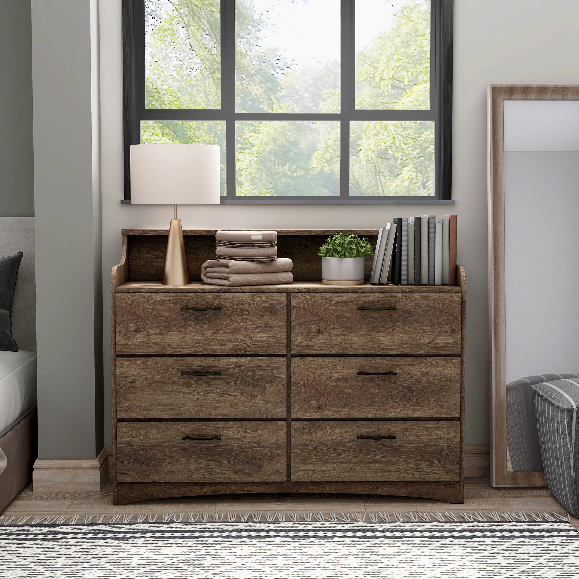 Front-facing transitional distressed walnut six-drawer double dresser with a tiered top in a bedroom with accessories