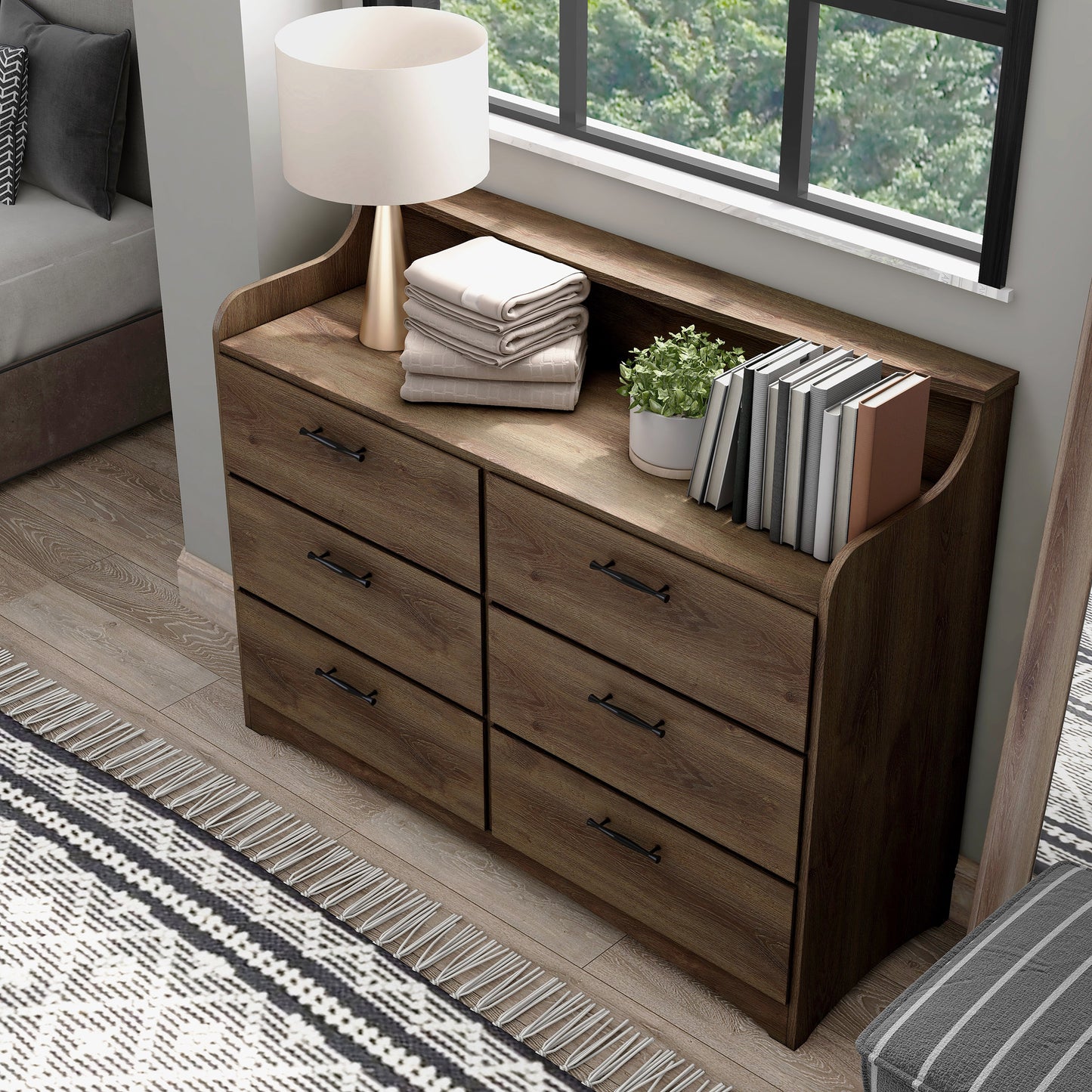 Left angled bird's eye view of a transitional distressed walnut six-drawer double dresser with a tiered top in a bedroom with accessories