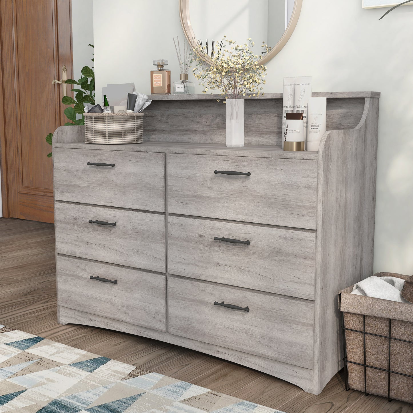 Left angled transitional coastal white six-drawer double dresser with a tiered top in a bedroom with accessories