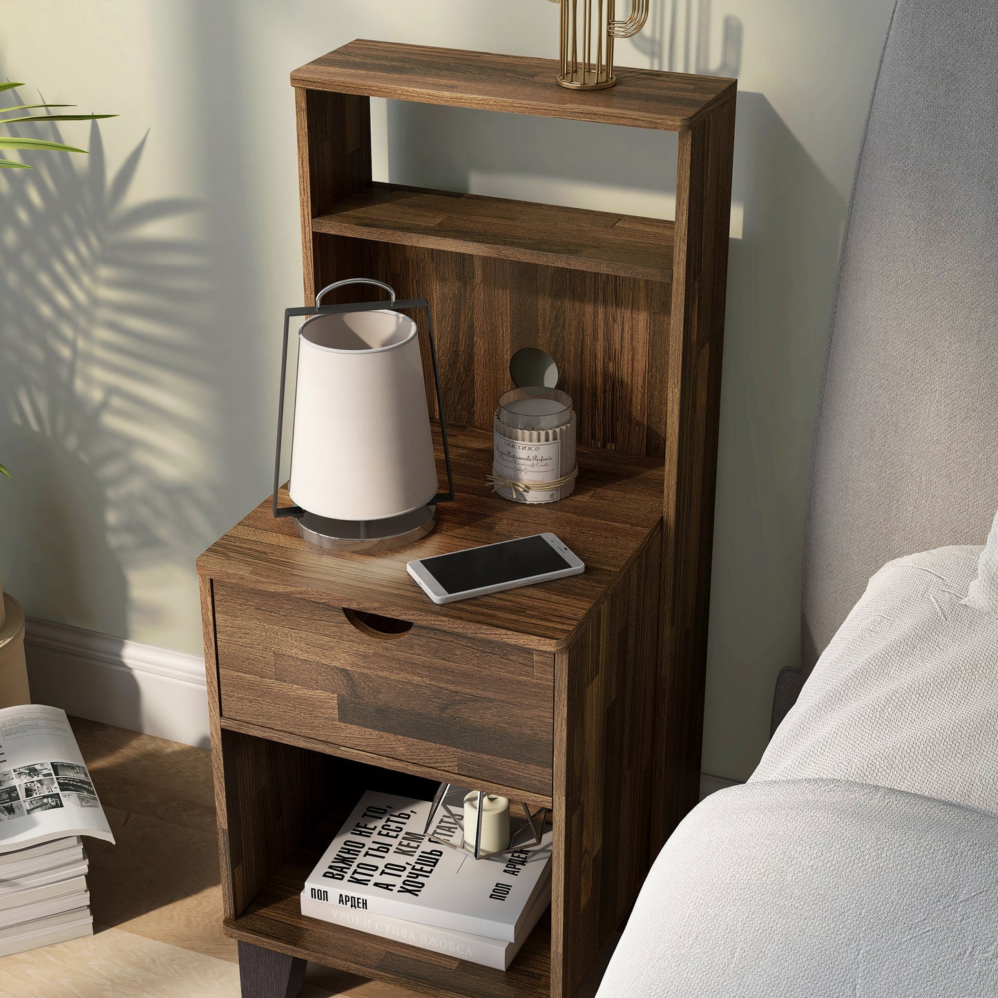 Left angled transitional light hickory three-shelf nightstand with one drawer in a bedroom with accessories