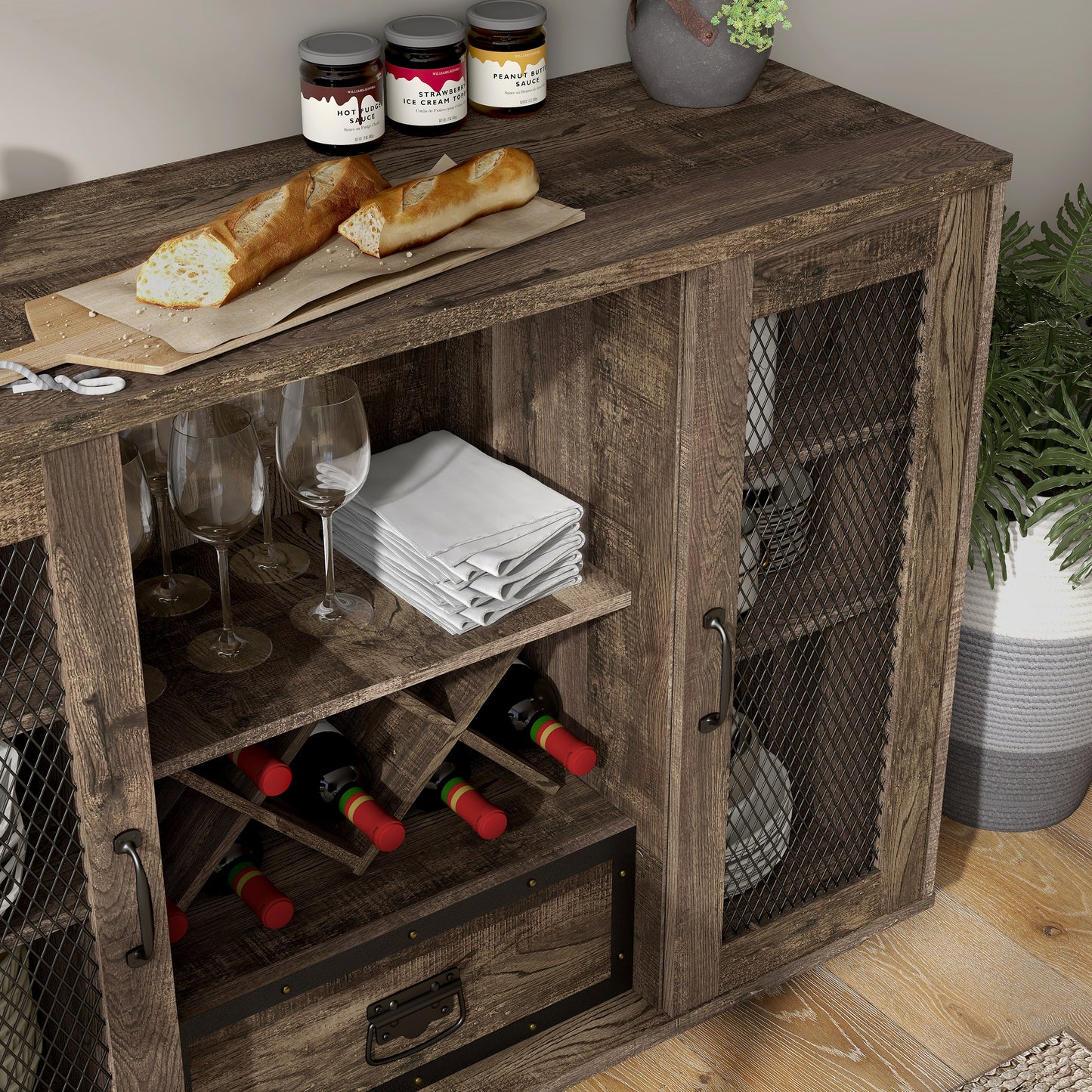 Right angled close-up view of a farmhouse reclaimed oak seven-shelf wine cabinet buffet with black mesh doors in a dining room with accessories