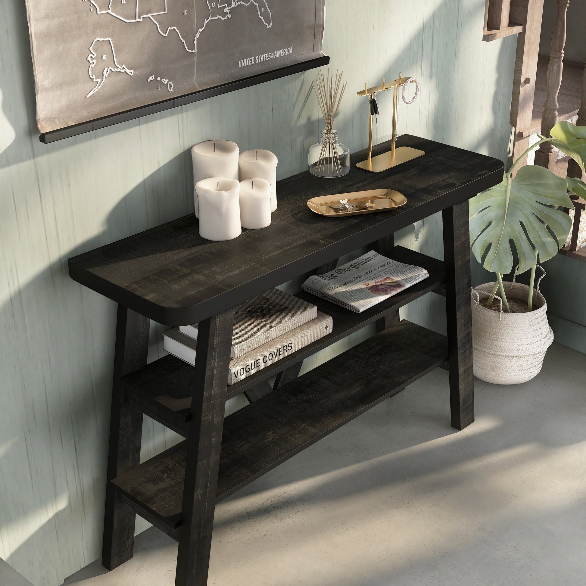 Right angled bird's eye view of a farmhouse reclaimed black two-shelf console table in a living area with accessories