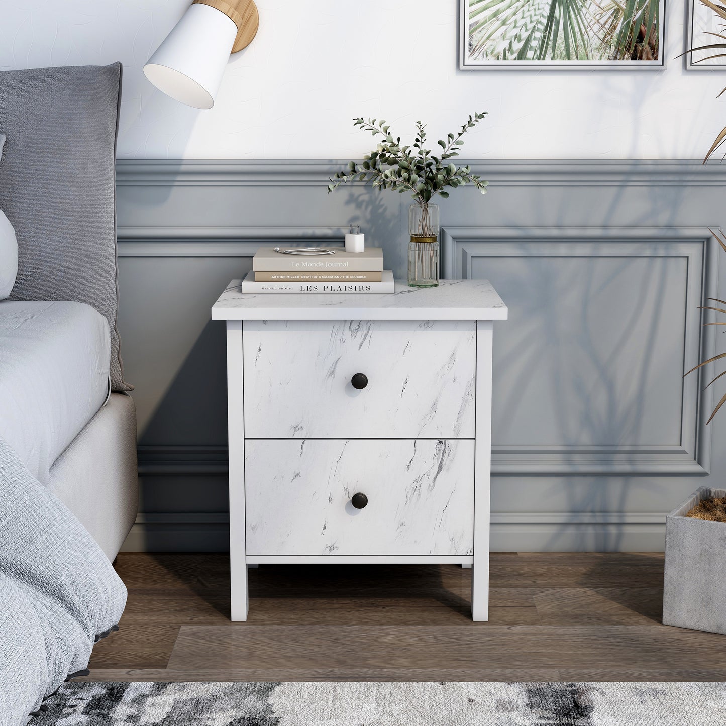 Front-facing transitional white faux marble two-drawer nightstand in a bedroom with accessories