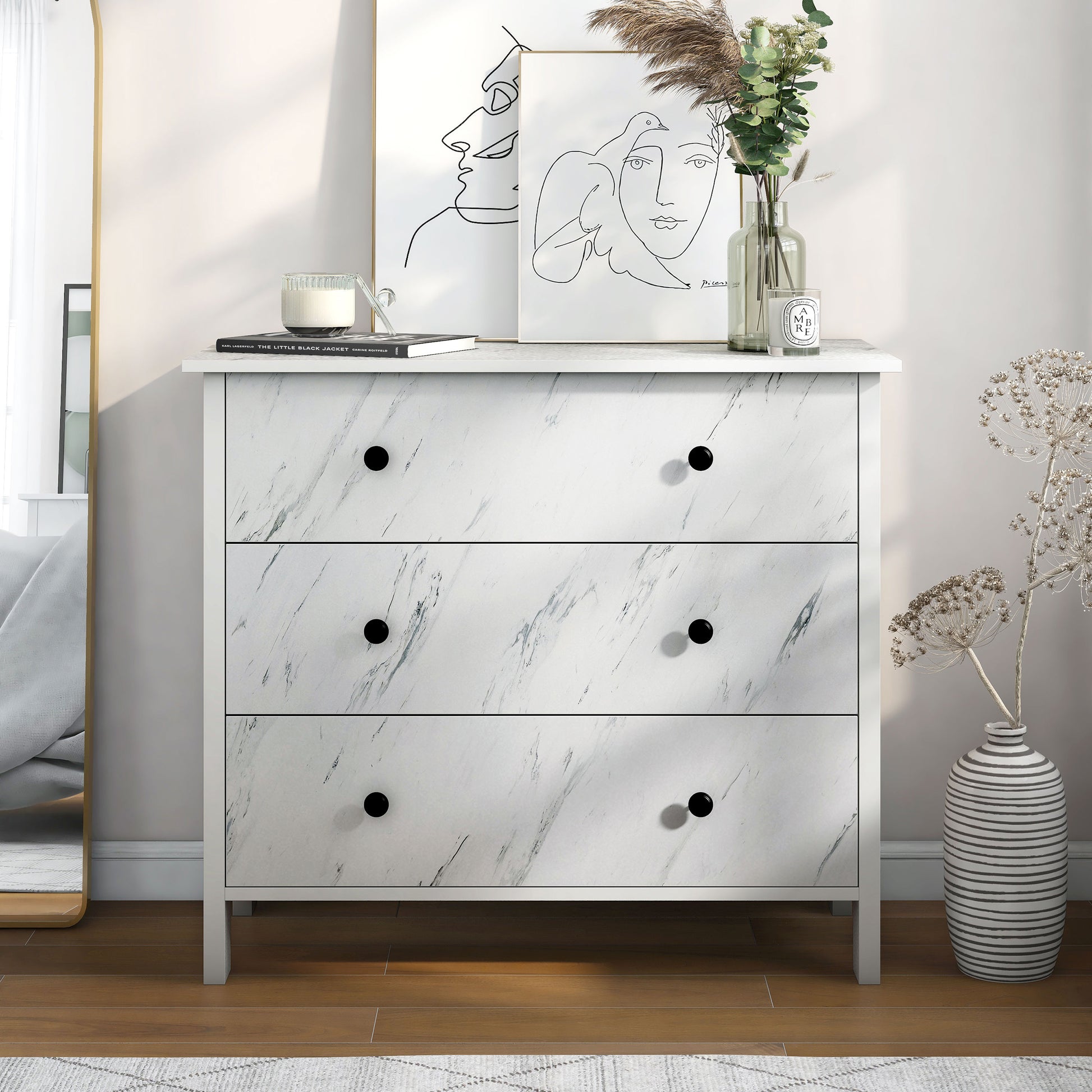 Front-facing transitional white faux marble three-drawer youth dresser in a bedroom with accessories