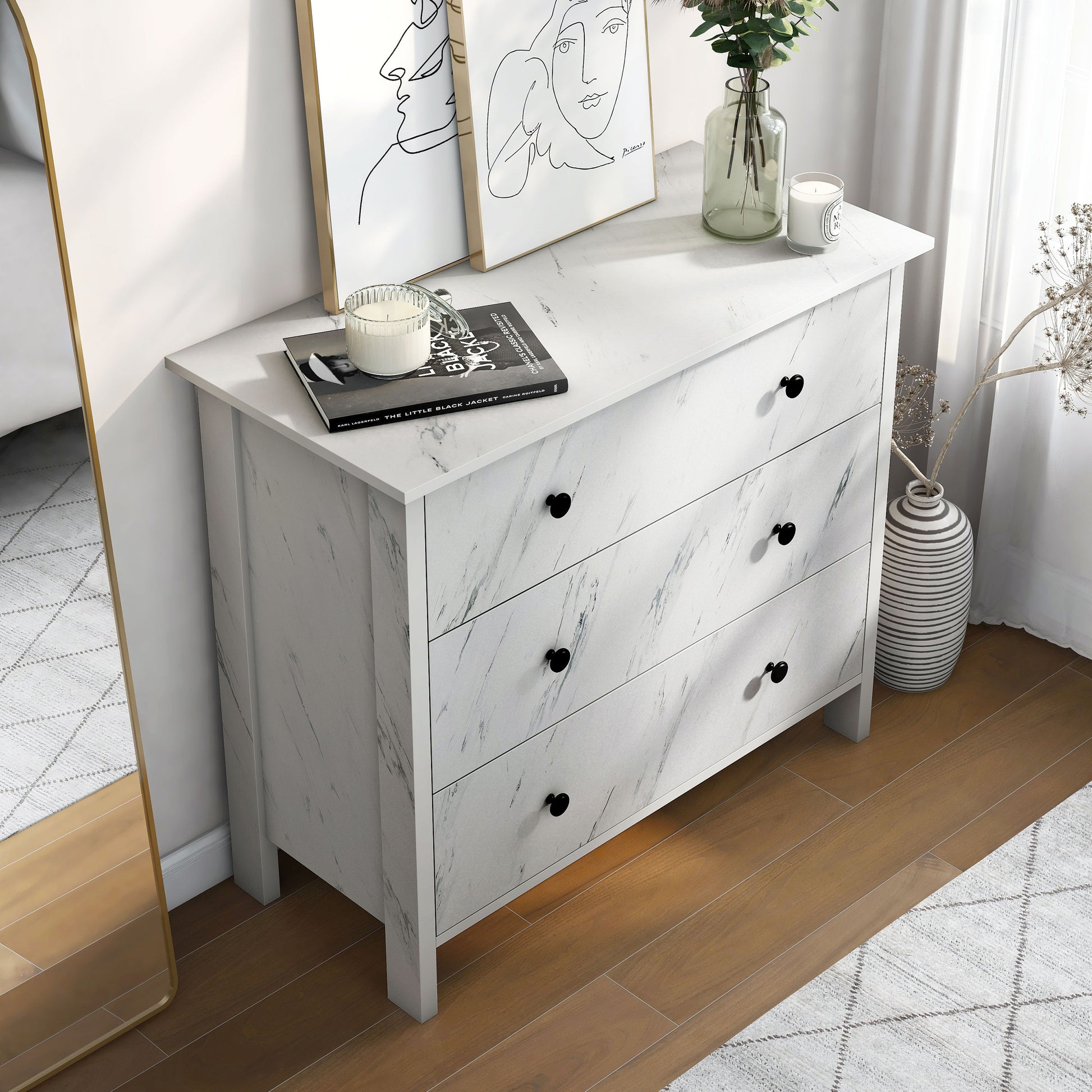 Right angled bird's eye view of a transitional white faux marble three-drawer youth dresser in a bedroom with accessories