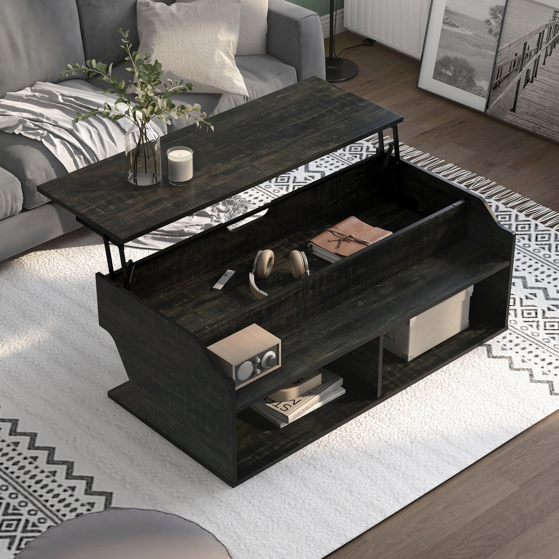 Right angled upper view of a transitional reclaimed black oak lift-top coffee table with storage and top raised in a living room with accessories