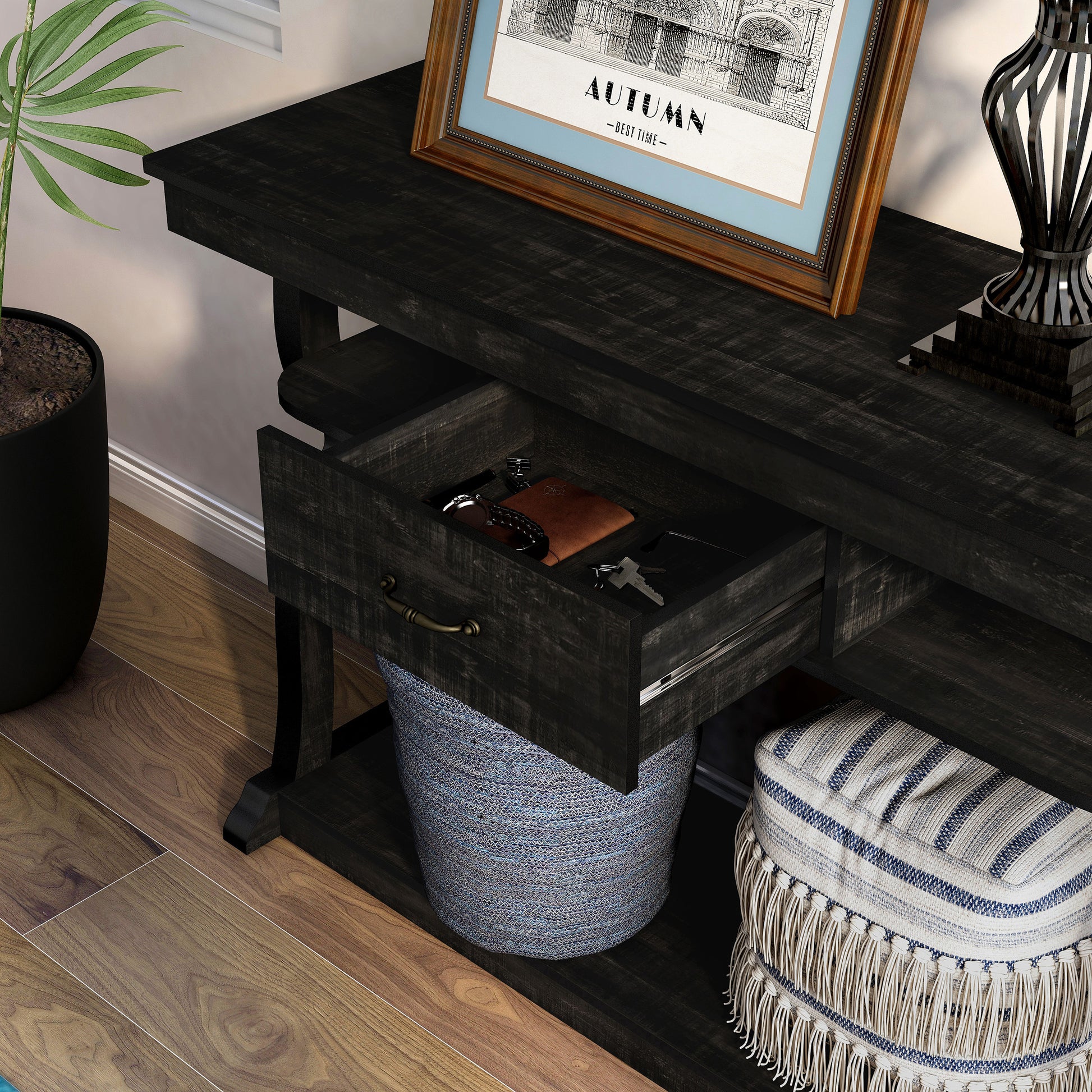 Left angled close-up view of a farmhouse reclaimed black oak three-shelf storage console table with a drawer open in a living room with accessories