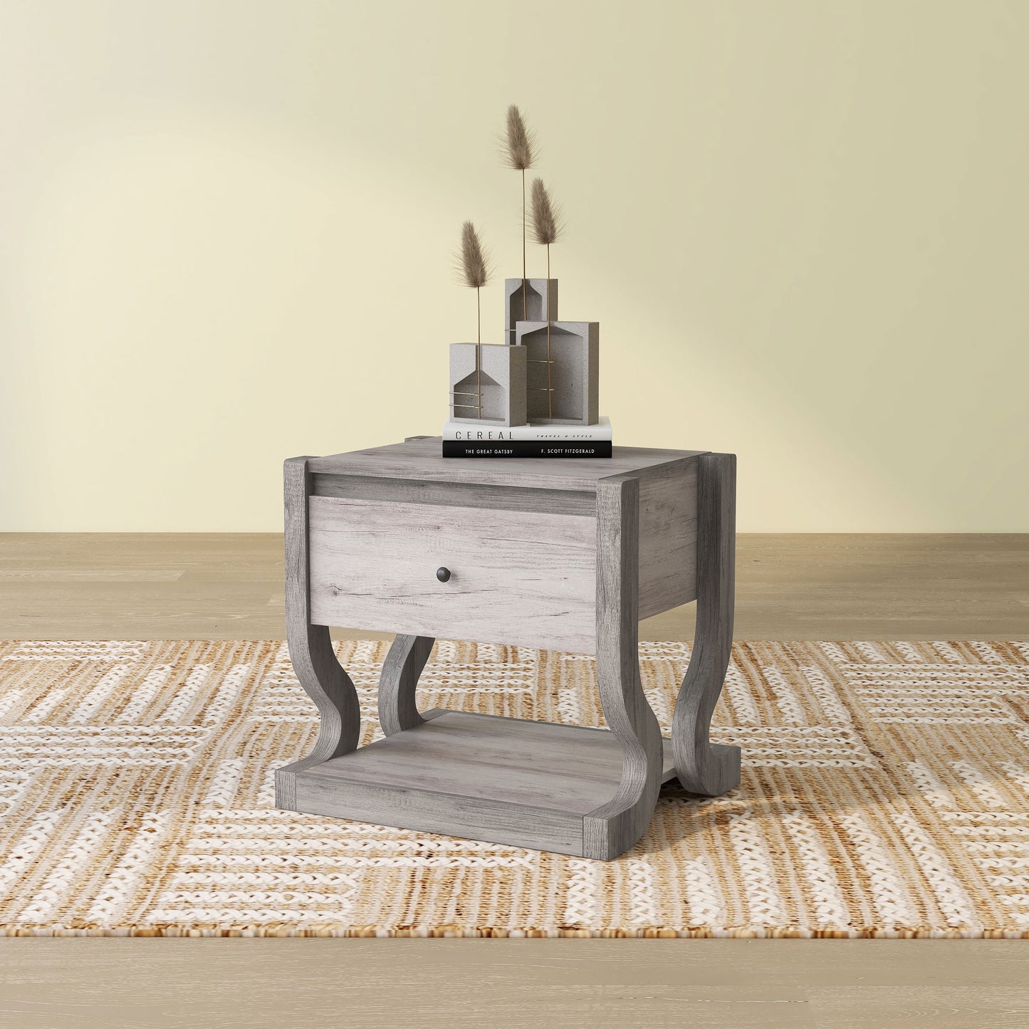 Left angled transitional coastal white one-drawer side table with a shelf on an area rug with accessories