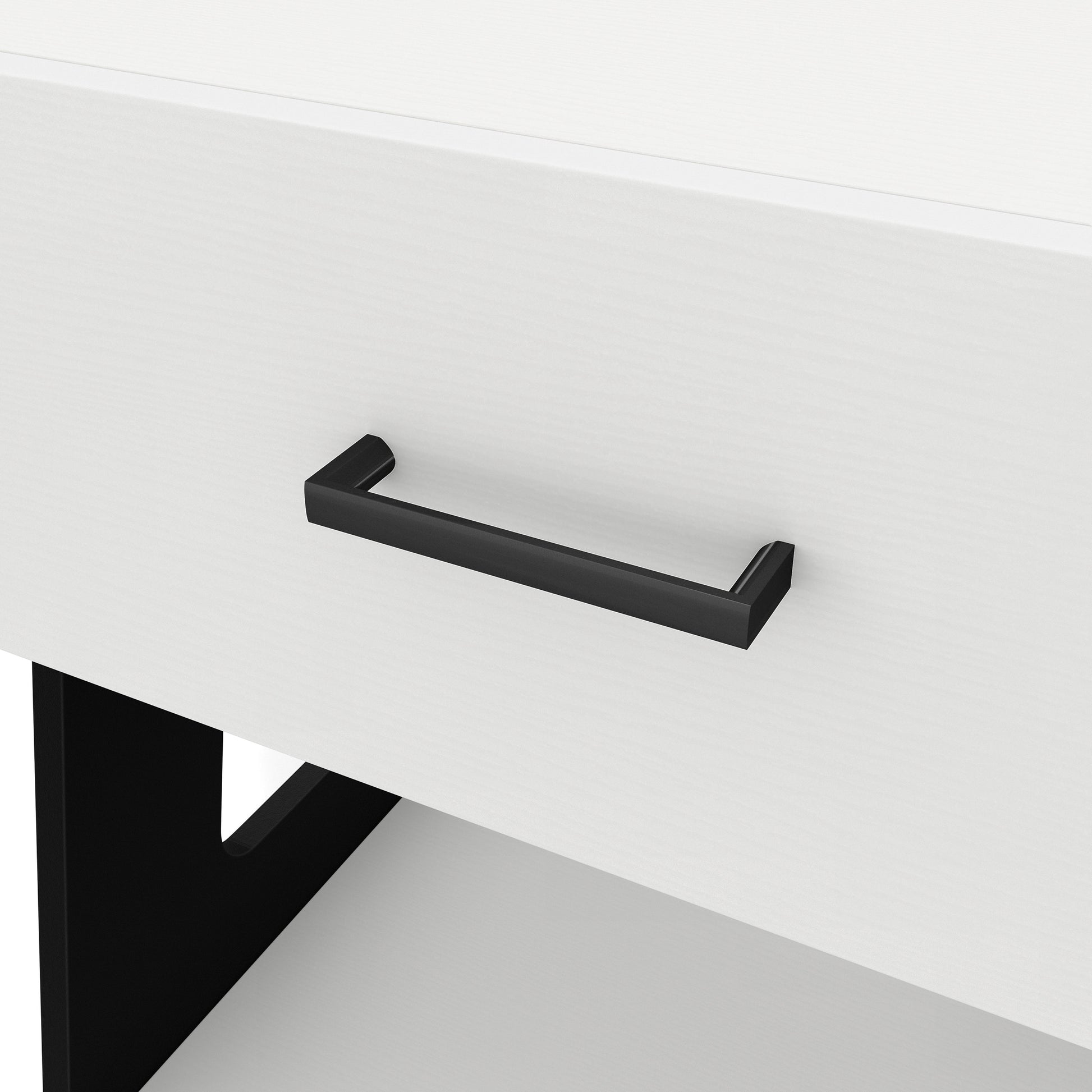 Left angled drawer pull close-up view of a contemporary white and black one-drawer side table with a shelf on a white background